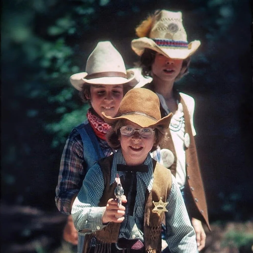 Children dressed in western costumes at a parade
