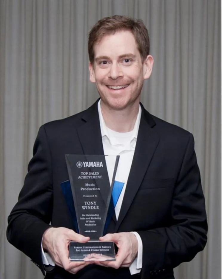 Tony Windle holding a Yamaha Top Sales Achievement award